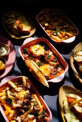 Variety of German main dishes including loaded fries, breads, and baked eggs